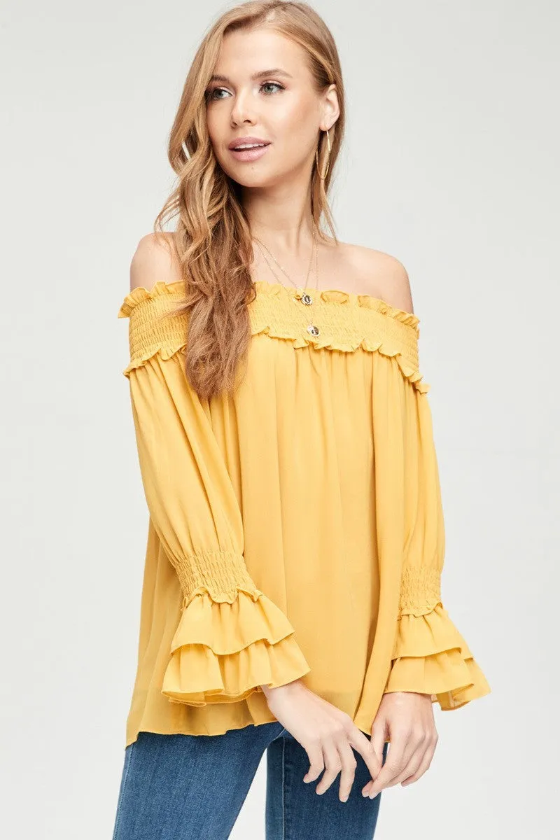 Off-shoulder blouse featuring smocked detail at neckline and sleeve - Mustard